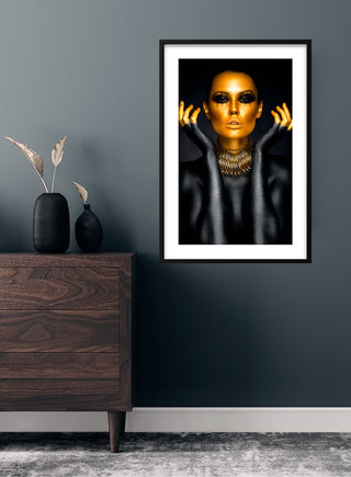 Golden Woman fashion poster featuring a striking portrait of a woman with gold makeup, displayed on a modern wall.