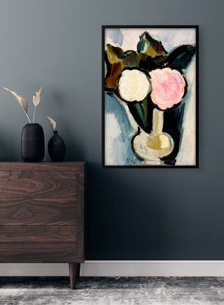 Poster of "Flowers in a Vase" by Marsden Hartley displayed above a dark wood dresser in a modern room.