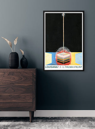 Hilma af Klint Exhibition poster on a dark wall above a wooden dresser with vases and dried plants.