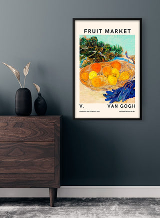 Van Gogh Fruit Market poster featuring colorful fruit, framed on a dark wall above a wooden dresser with decor.