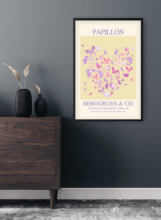 Framed Inspired Papillon No. 04 Plakat featuring colorful butterflies on a wall above a wooden dresser.