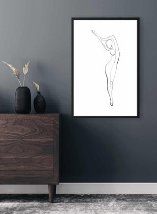 Minimalist line art of an elegant woman posing, framed and displayed on a dark wall above a wooden dresser.