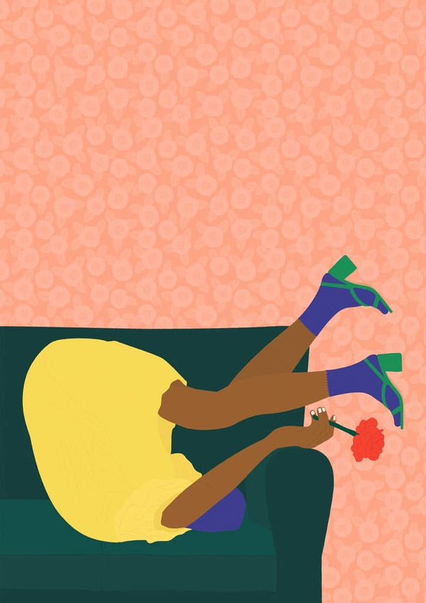 Person in a yellow dress holding a red flower, playfully posing upside down on a sofa for New Year's Eve.
