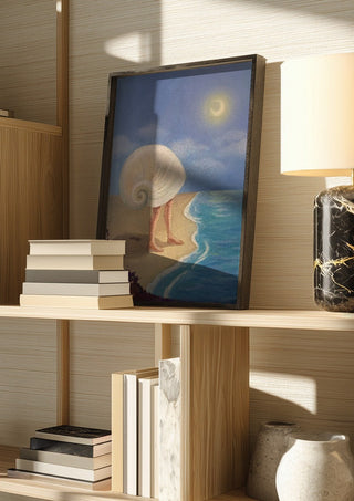Return to the sea by NeReid in a dark frame on a wooden shelf beside books and a lamp