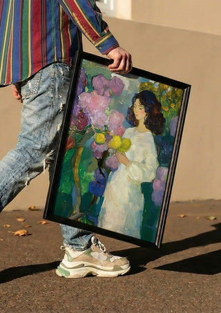 Girl with Yellow Flowers by Elena Avanesova carried in a black frame along a sunny street