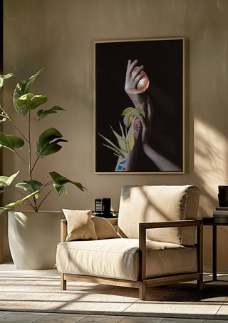 Hypnopompic by Rocio Montoya framed above a beige armchair beside a potted plant