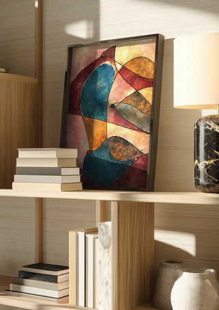 When Doves Cry by Art Guveau in a dark frame on a wooden shelf beside books and a lamp