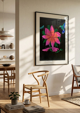 Flora e Fauna by KG Studio in a black frame in a bright dining room with wooden chairs
