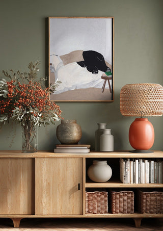 Dream department by Jaron Su above a wooden sideboard on a sage green wall