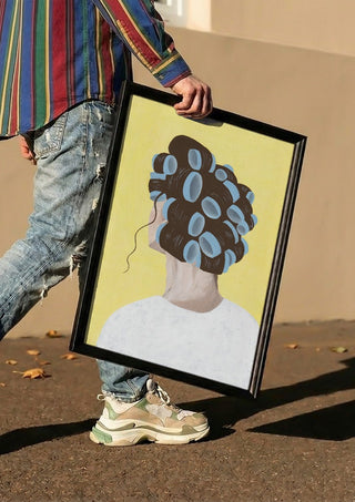 Different solution by Jaron Su carried in a black frame along a sunny street