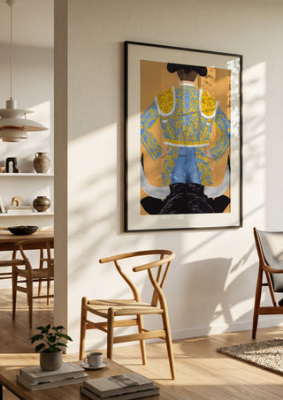 Butt fighter by Jaron Su in a black frame in a bright dining room with wooden chairs