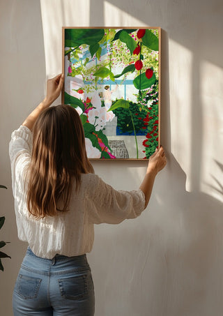 Artist paints in naked workshop by Jaron Su being hung on a sunlit wall
