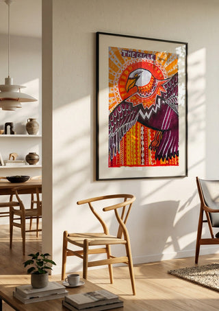 Eagle in the sky by ALEX in a black frame in a bright dining room with wooden chairs