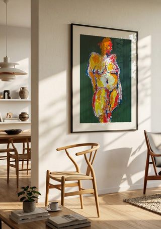 Standing Nude by René J in a black frame in a bright dining room with wooden chairs