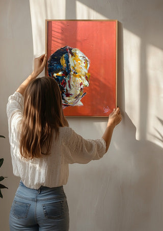 Head in Colour by René J being hung on a sunlit wall