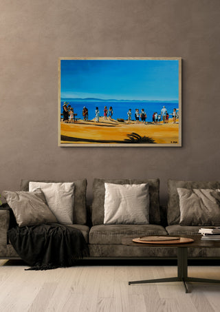 Above Rhodes Town by Nella Hajdu in a light wood frame above a grey sofa with cushions
