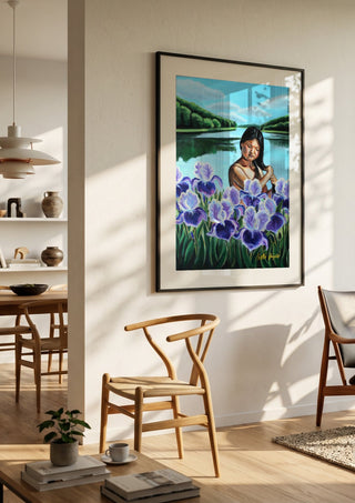 Awakening by Nella Hajdu in a black frame in a bright dining room with wooden chairs