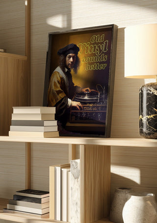 Old Vinyl Sounds Better by Dikhotomy in a dark frame on a wooden shelf beside books and a lamp