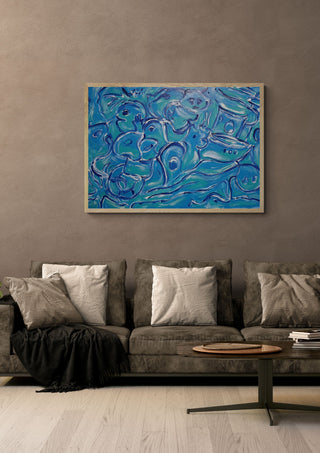 Was das Meer trägt · What the Sea Carries by ELIZA Leopold in a light wood frame above a grey sofa with cushions
