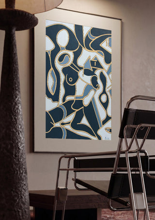 Erotica by Andreas Pohle framed in a dim room beside a tubular steel chair