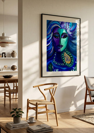 Blue Muse by Da Winters in a black frame in a bright dining room with wooden chairs