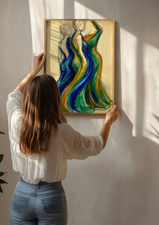 Two Gowns by Da Winters being hung on a sunlit wall
