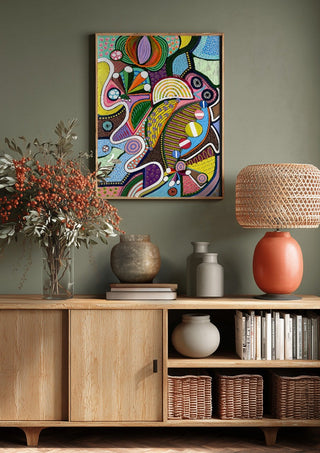 Peaceful Power by LGDyrby above a wooden sideboard on a sage green wall