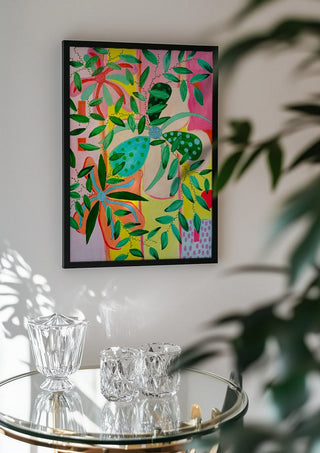 Bloom by LGDyrby in a black frame above a glass table with crystal glassware