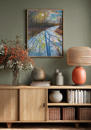 Shadows of the Day by Finbar Stevens above a wooden sideboard on a sage green wall