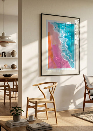 Pink hour on the beach by Ohkimiko in a black frame in a bright dining room with wooden chairs