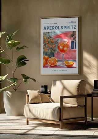 Il dolce far niente - Aperol by Ohkimiko framed above a beige armchair beside a potted plant