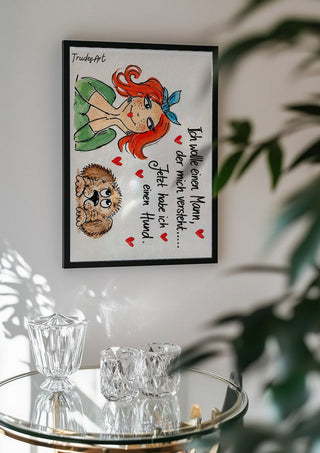 Ich wollte einen Mann by Trude in a black frame above a glass table with crystal glassware