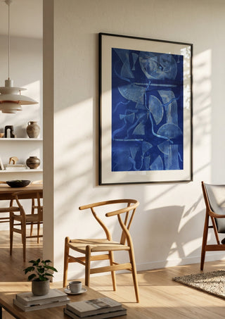 Curved lines / blue field by Linor Citaku in a black frame in a bright dining room with wooden chairs