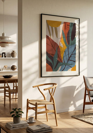 Abstract Art Jungle by ThingDesign in a black frame in a bright dining room with wooden chairs
