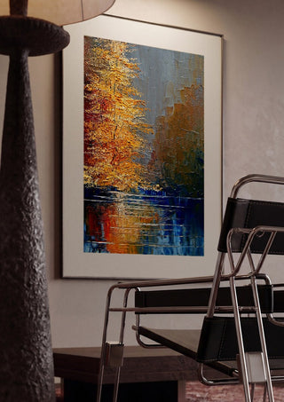 Autumn on the Water by Justyna Kopania framed in a dim room beside a tubular steel chair