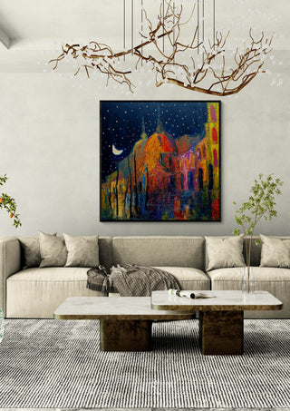 Crescent over the Domes by Justyna Kopania in a black frame above a cream sofa under a branch chandelier