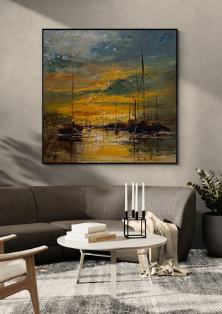 Evening Gold by Justyna Kopania in a black frame above a dark sofa with candlesticks on a round table