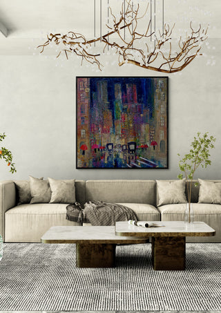 Rain on the Boulevard by Justyna Kopania in a black frame above a cream sofa under a branch chandelier