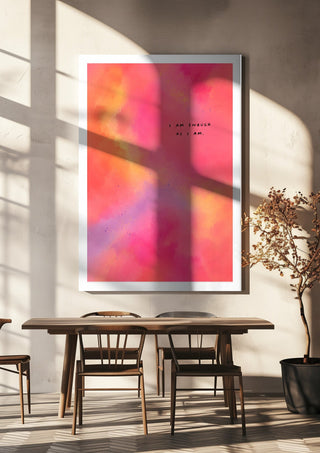 I Am Enough by Decker Studios hanging above a wooden dining table in warm sunlight