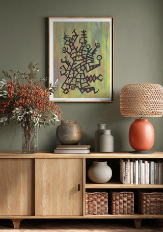 Glyphs on Green by John Larkin above a wooden sideboard on a sage green wall