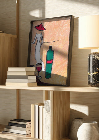 Lady in the Red Hat by Camilla Nilsson in a dark frame on a wooden shelf beside books and a lamp