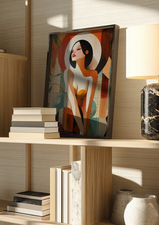 Golden Silence by ArtySjak in a dark frame on a wooden shelf beside books and a lamp