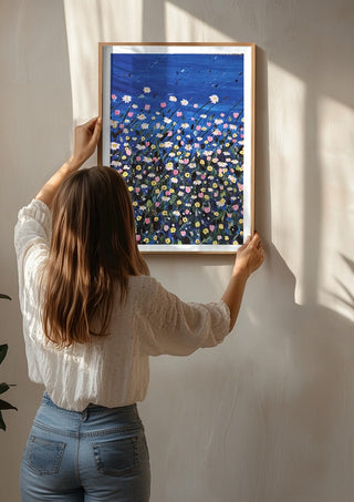 Daisies by Rebecca Wright being hung on a sunlit wall