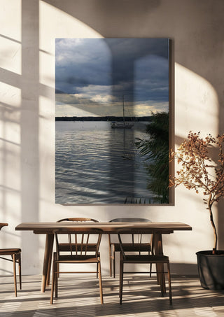 Light Reaching the Water by Bora Kőhalmi hanging above a wooden dining table in warm sunlight