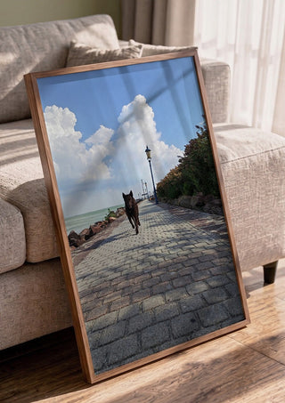 Departure and Return by Bora Kőhalmi in a walnut frame leaning against a grey sofa