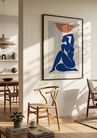 Abstract Nude Art Inspired by Henri Matisse by TimlessArtworks in a black frame in a bright dining room with wooden chairs