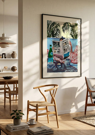 Sunday read at The Phoenicia, Malta by Mariam De Giorgio in a large black frame in a bright dining room