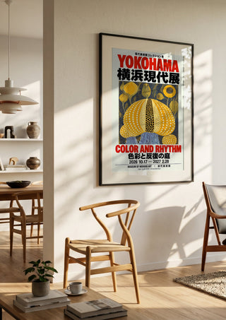 Color and Rhythm Poster by Yokohama in a black frame in a bright dining room with wooden chairs