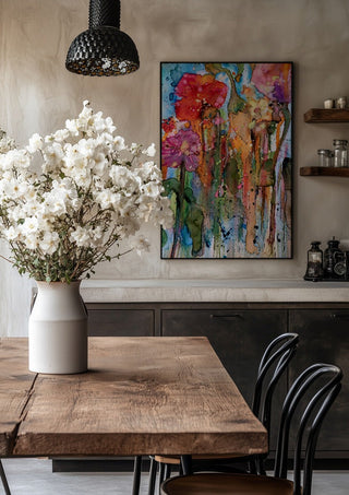 riot garden by hazelart in a black frame above a rustic table with white flowers
