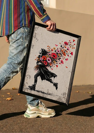 Running with Spring by Matthews Gallerie carried in a black frame along a sunny street